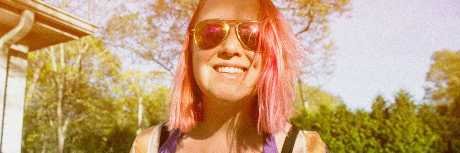 Finding Passion for Photography Through Ehlers-Danlos Syndrome (EDS) photo of woman with red hair and sunglasses