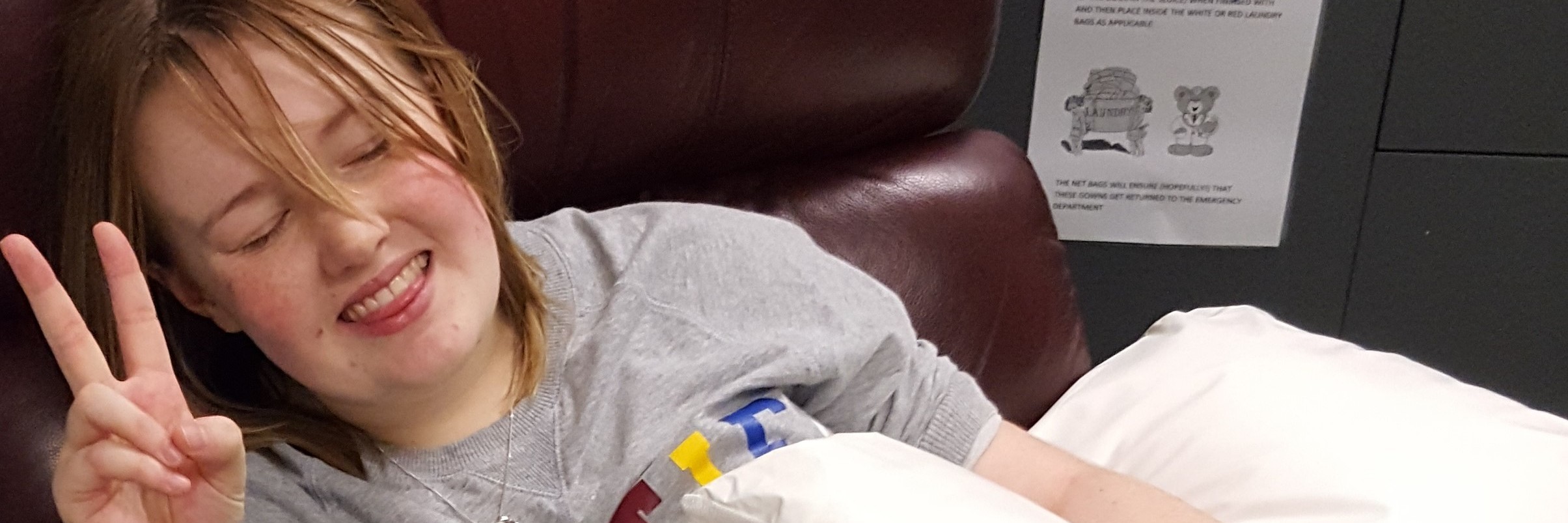 The Power in Defining Your Chronic Illness The writer sitting in a big chair, with an IV in her hand.