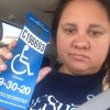 woman holding disability placard in car