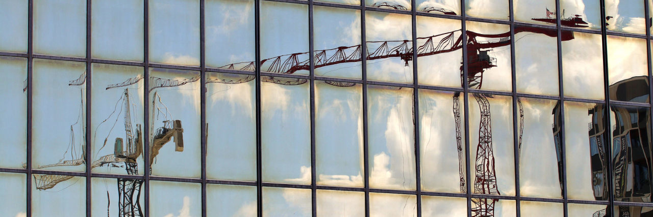 Photography Helped Me Recover From Post-traumatic Stress Disorder image of blurred out cranes reflected in window