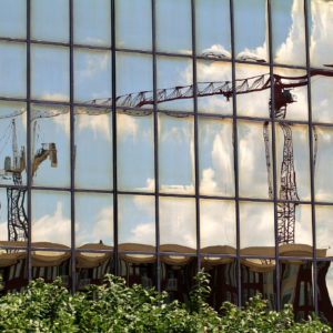 image of blurred out cranes reflected in window