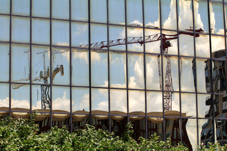 image of blurred out cranes reflected in window