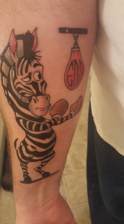 tattoo of cartoon zebra hitting a punching bag