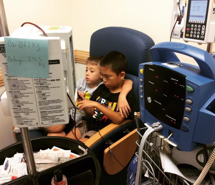two boys receiving blood transfusion