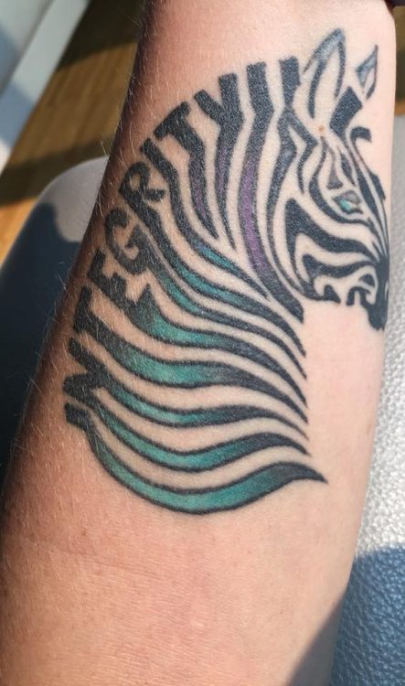 tattoo of zebra with the word 'integrity'