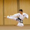 contributor image of asian man kicking through air