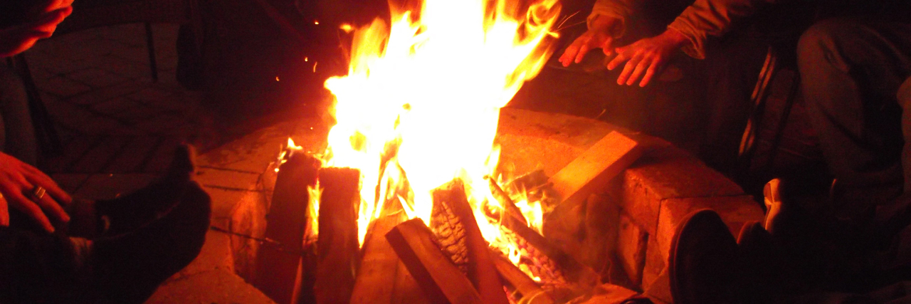 Trusting Men After My Past Trauma campfire surrounded by people in shadow