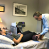 Dr. Michael Cooney performing therapy on a patient in his office