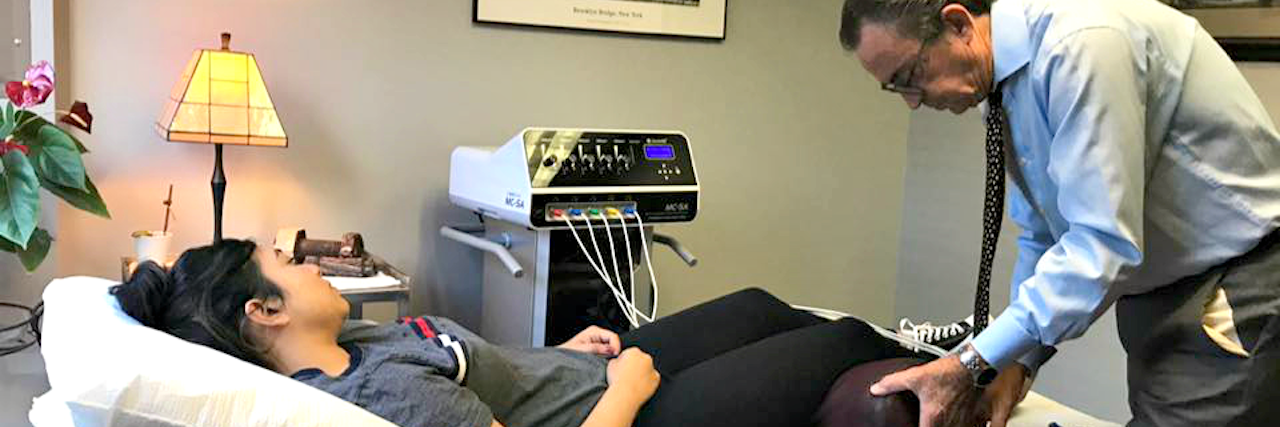 How to Find an Alternative Medicine Provider to Treat Chronic Pain Dr. Michael Cooney performing therapy on a patient in his office