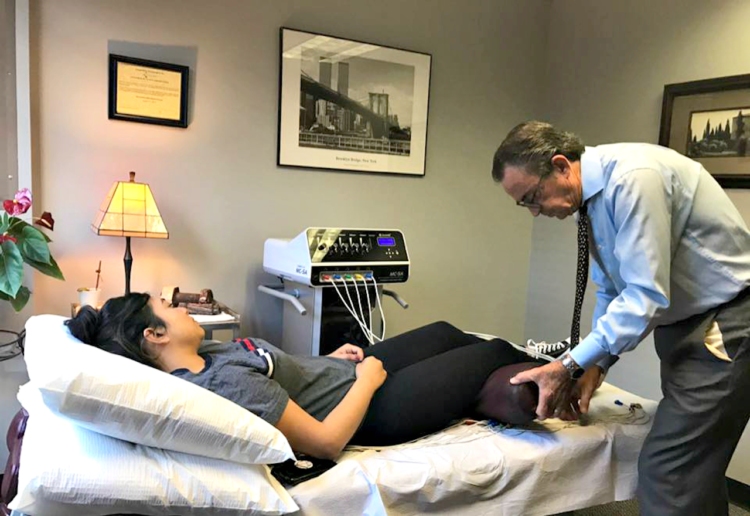 Dr. Michael Cooney performing therapy on a patient in his office