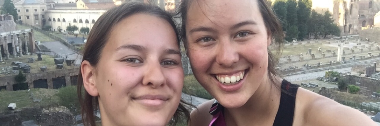 How Travel Planning Changes With Lupus two women taking a photo in front of the roman forum