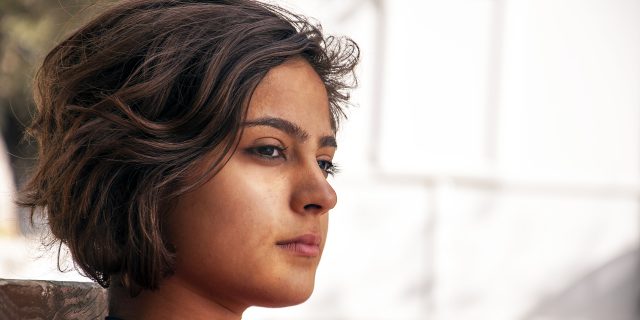 young woman with short hair thinking