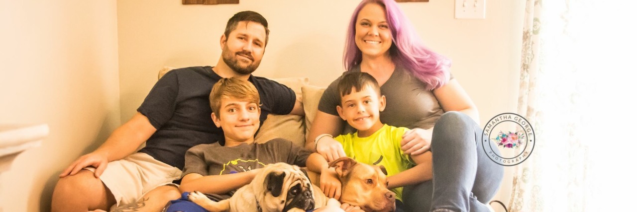 Living With Long QT Syndrome After Near-Death Experience mother, father and two songs sitting on couch at home