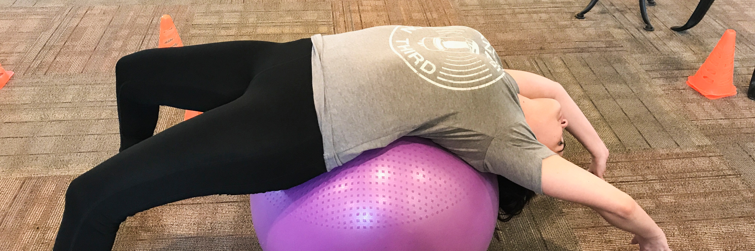 Recovering From Endometriosis Surgery With Pelvic Physical Therapy woman stretching her back on a balance ball