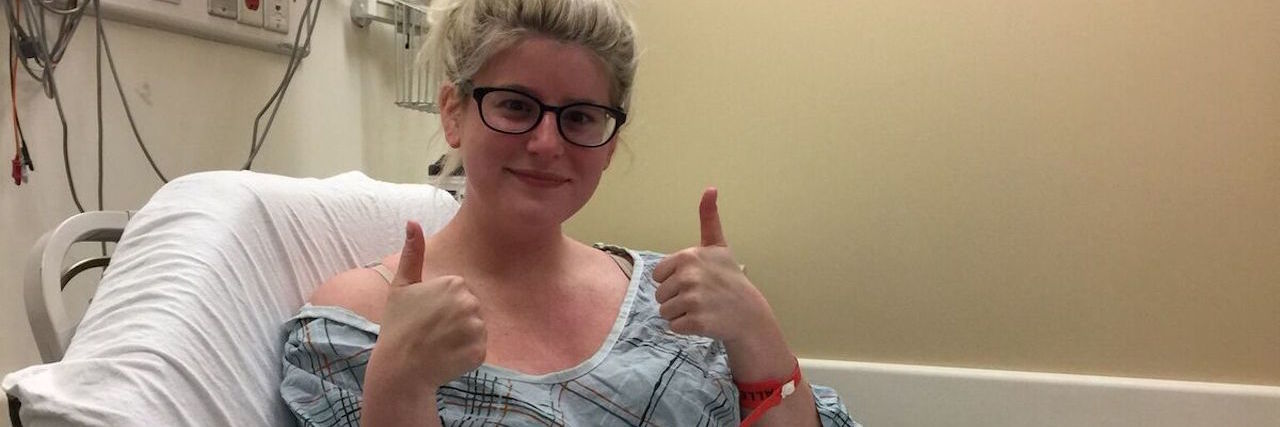 It's OK to Feel Depressed, Anxious, Upset After Lupus Diagnosis woman giving a thumbs up from her hospital bed