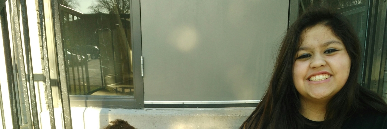 Open Letter to My Cerebral Palsy Heaven holding up a sign for cerebral palsy awareness.