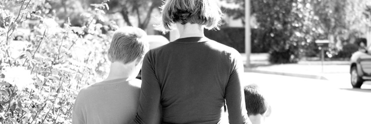 Sometimes I Feel Like I’m Still Surviving My Husband’s Suicide woman and two sons