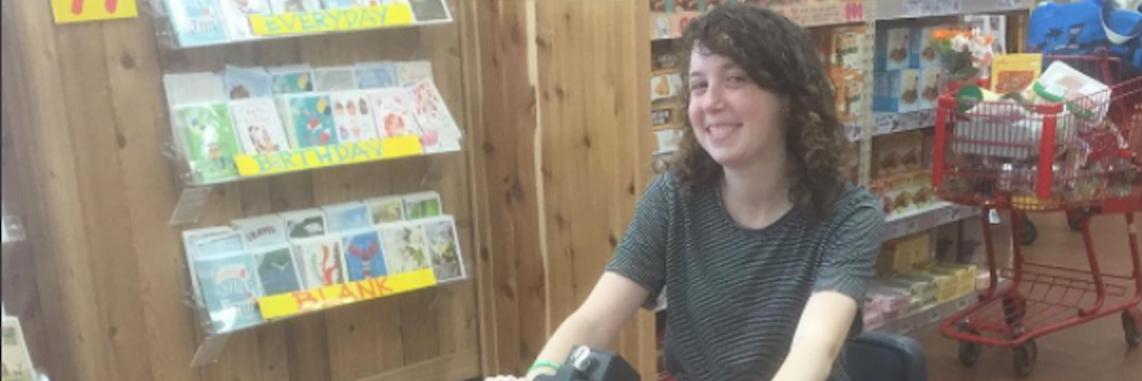 What It's Like to Be Diagnosed With RA After College Graduation The writer in an electric wheelchair at a store.