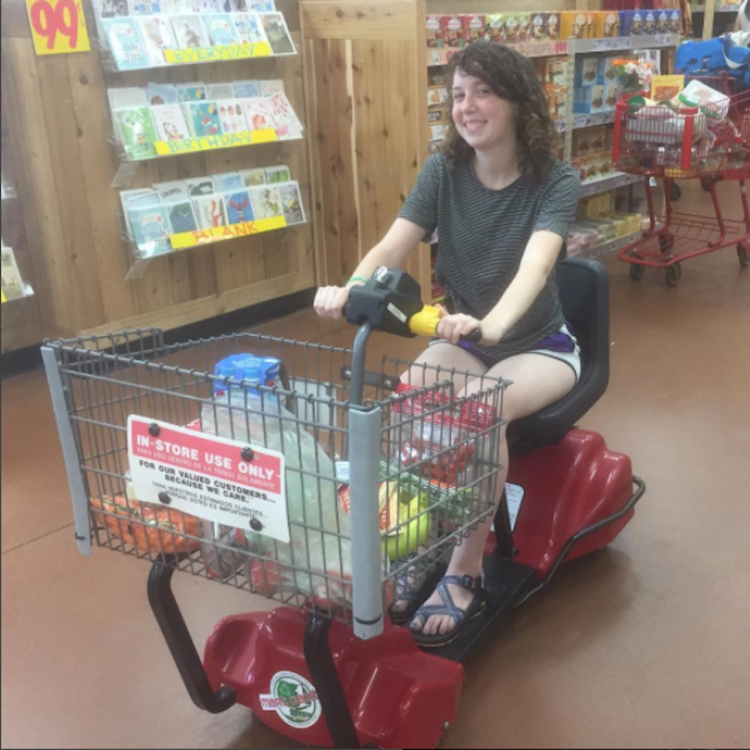 The writer in an electric wheelchair at a store.