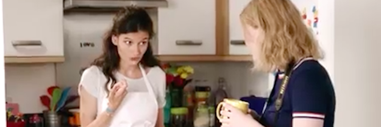 Creating a Web Series About My Eating Disorder a woman stands in her kitchen talking to another woman holding a cup