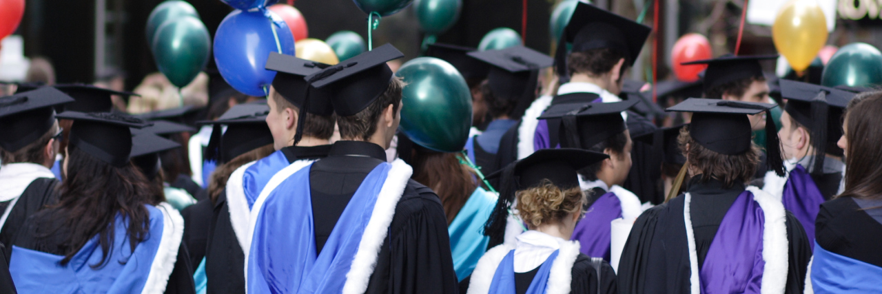 Issues With Disability in Higher Education, Graduate School graduate students wearing their caps and gowns at a ceremony