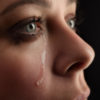 A close-up of a woman crying.