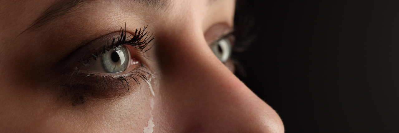 The Grief That Comes From a Life With Chronic Illnesses A close-up of a woman crying.