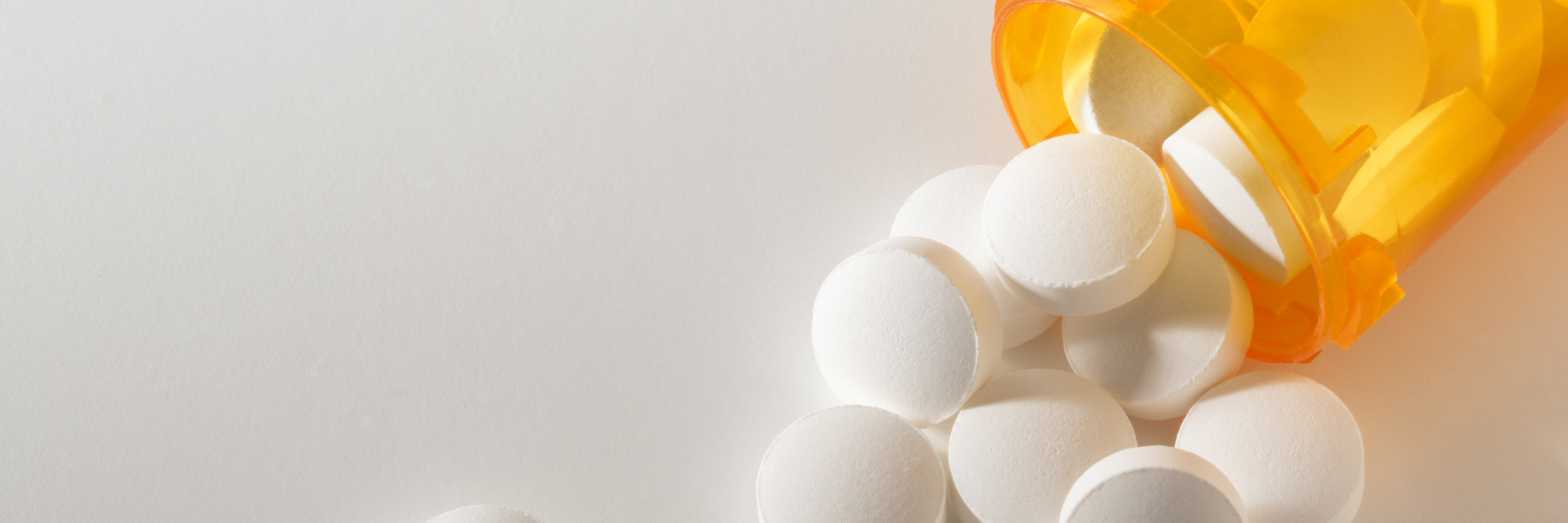 How War on Opioids, Drug Addiction Affects Patients With Chronic Pain pill bottle pouring out medication onto the table