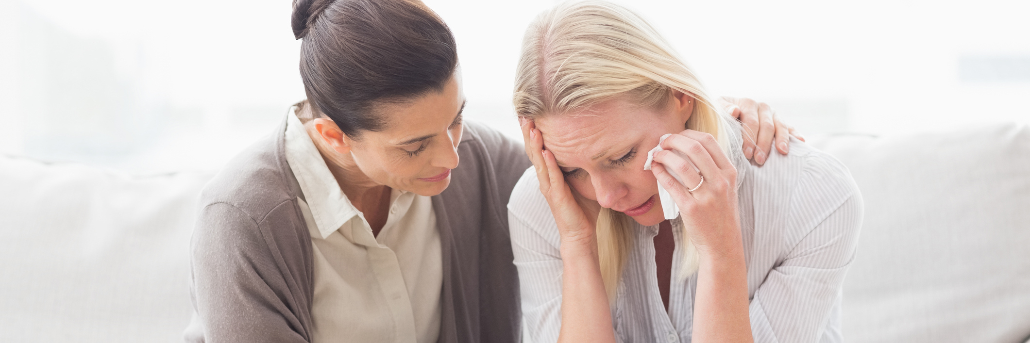 When a Therapy Client Asked Me 'Do Therapists Cry?' patient crying on sofa next to therapist
