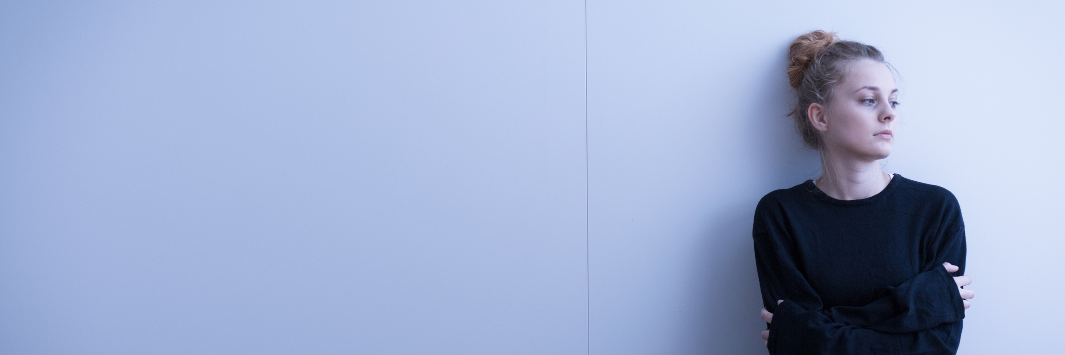 McArdle's Disease: Experiencing Prejudice Against Chronic Illness woman sitting on the floor with her arms crossed