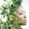 Double exposure portrait of woman combined with photograph of leaves