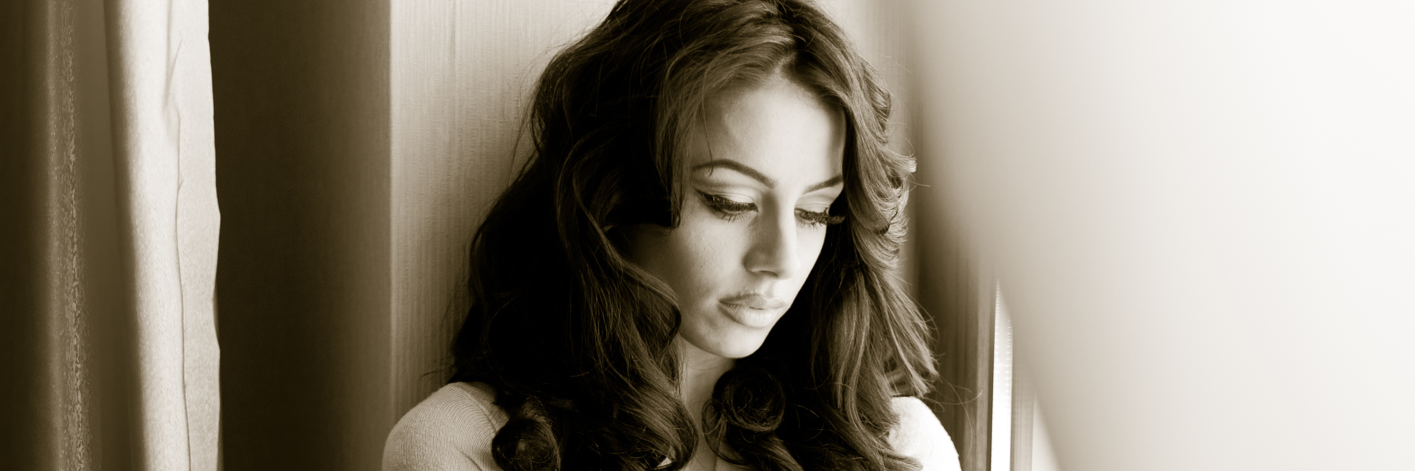 What It's Like Having Hidradenitis Suppurativa Woman sitting by a window.