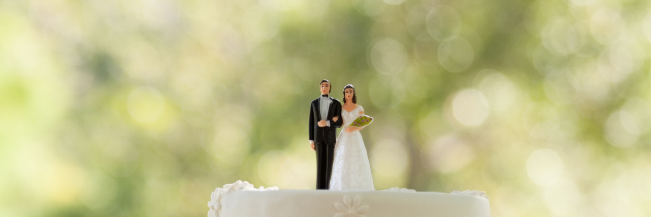 How I’m Coping With Body Image Pressure as a Bride wedding cake and cake topper of bride and groom