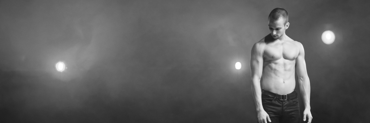 Bipolar Disorder Recovery Takes Everything Working Together young man standing on stage solo with smoke and lights