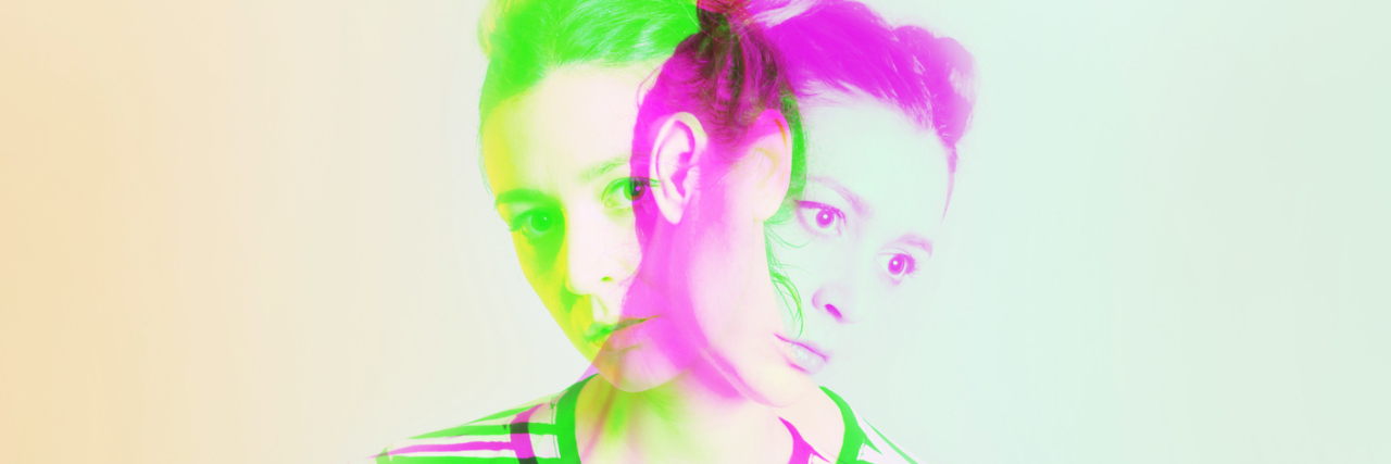 Studio portrait of young woman with colorful 3d effects