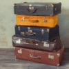 Many old suitcases stand in an empty room