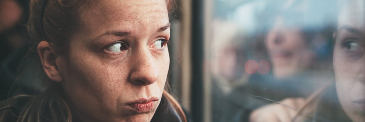 Taking Care of Yourself With a Mental Illness and Autoimmune Disease Young woman feeling alone in the public transport