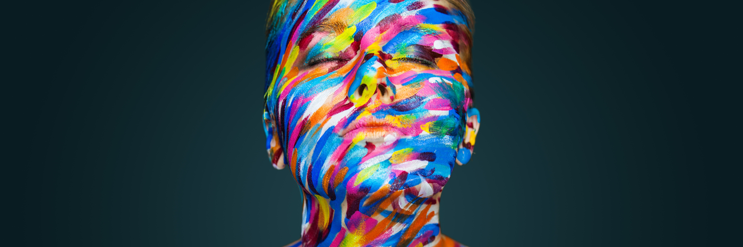 A photo of a woman with colorful body paint on.
