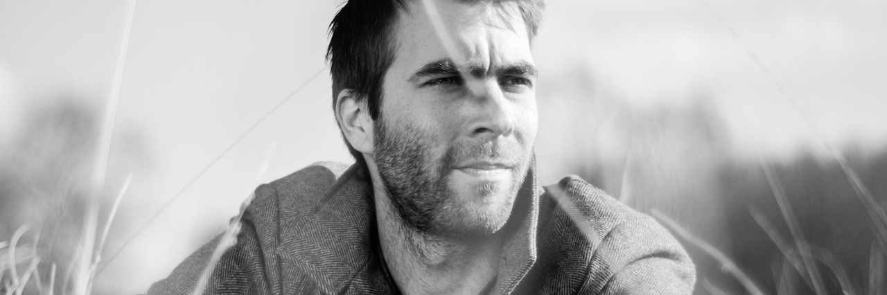 7 Things You Might Not Know If You Don't Have PTSD Man outside, sitting in grass