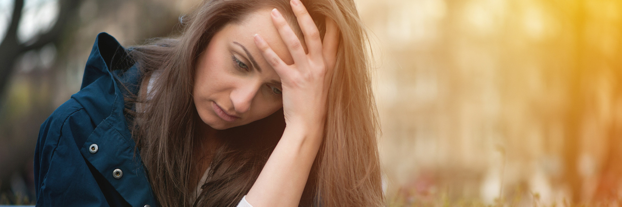 What It Feels Like to Have Hypochondria A woman looking at her phone