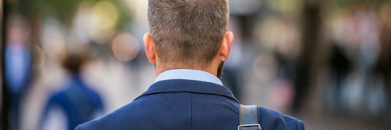 Stuttering, Acceptance and Peace Back view of man walking down street wearing suit