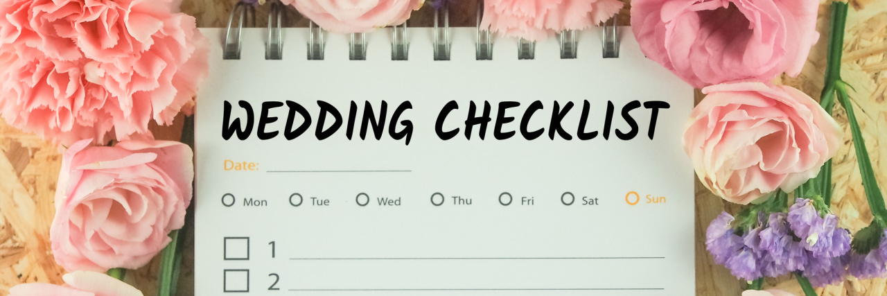 A wedding checklist, surrounded by pink flowers.