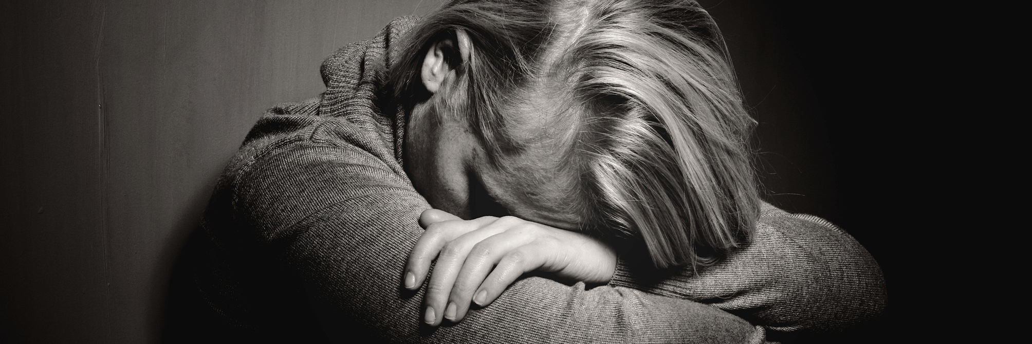 What a Pain Level of 10 Feels Like black and white image of woman resting head on arms