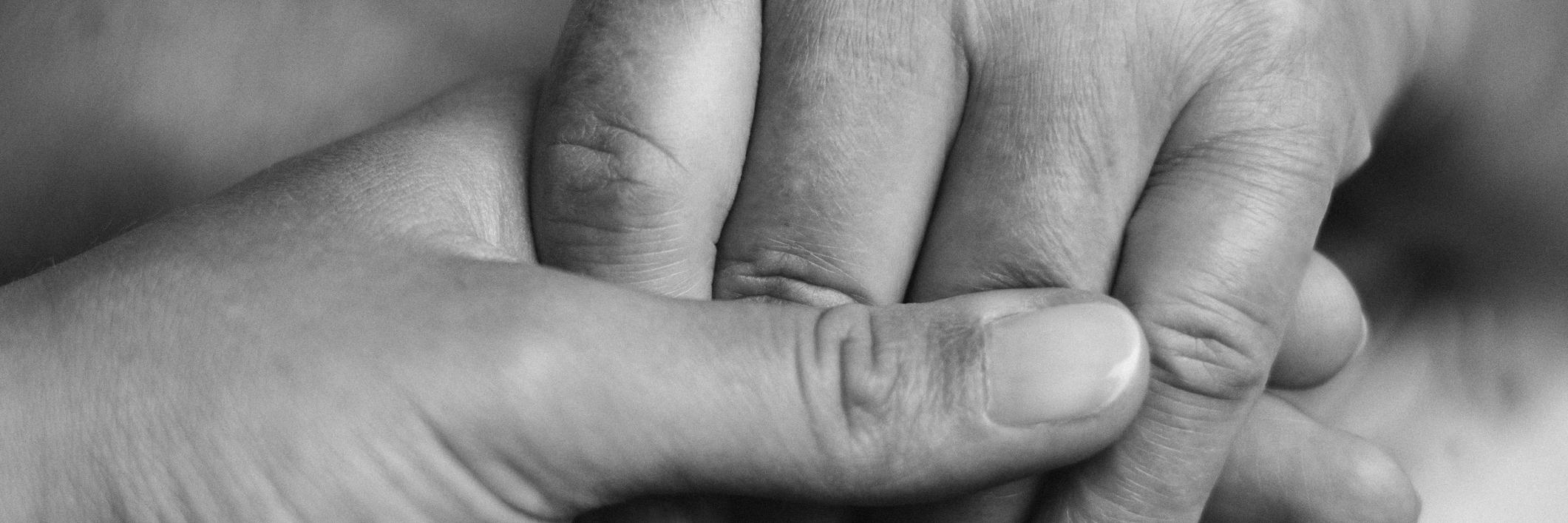 black and white photo of hands holding