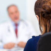 female patient talking to male doctor consultant