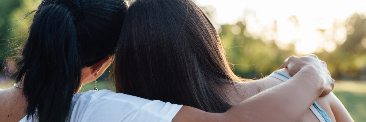I Wish I Was Able to Protect My Daughter From Her PTSD Triggers Closeup of mom and daughter embracing on a park bench