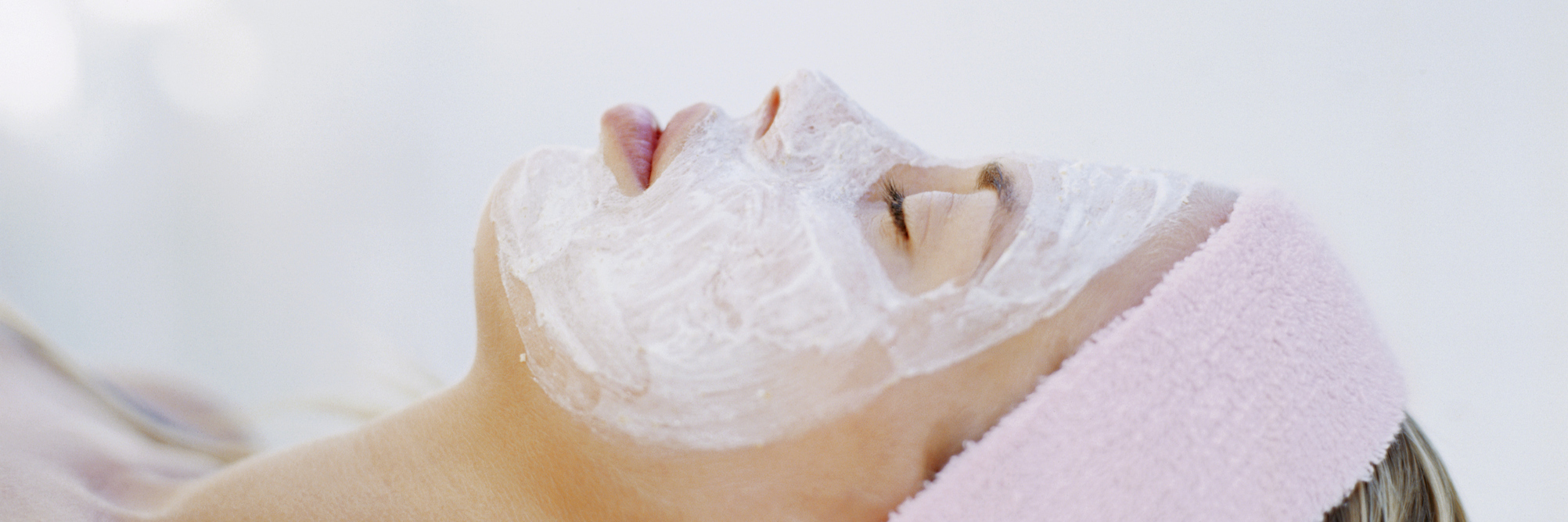 The Importance of Occasionally Getting Pampered When You're Ill A side profile of a woman laying down, wearing a facial mask.