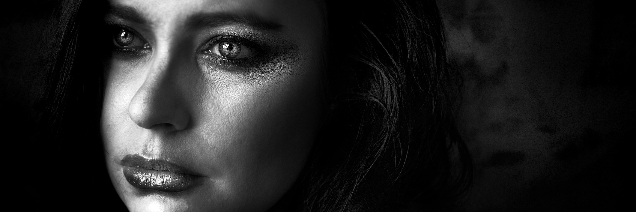 Black and white close-up of woman looking away from camera.