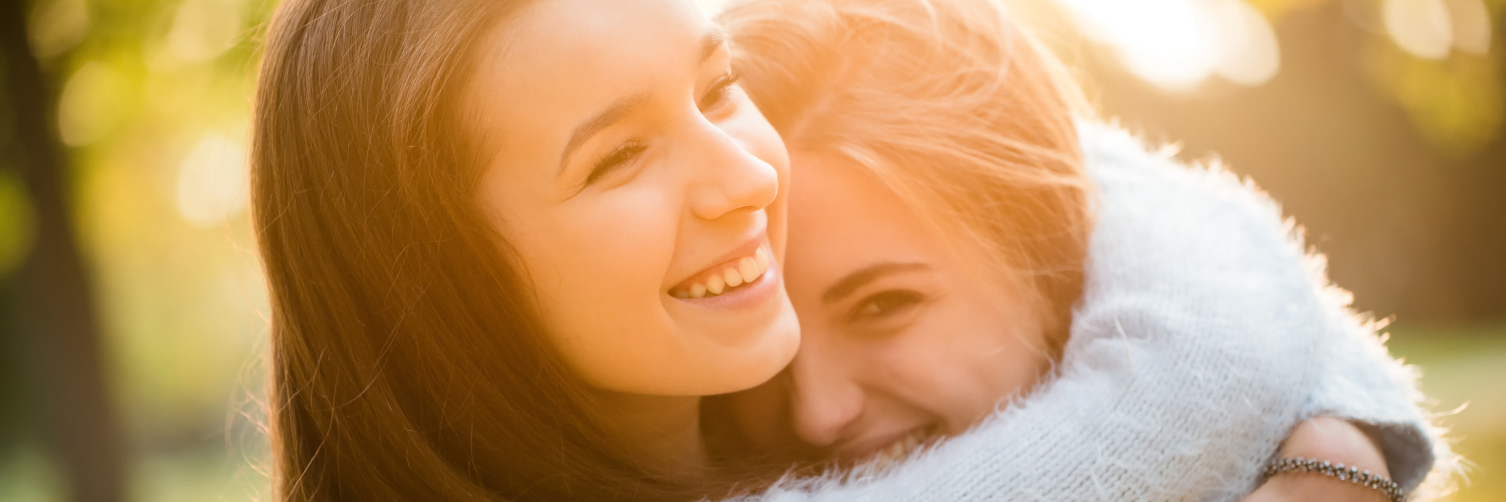How to Support a Friend With Chronic Illness and Their Partner two friends hugging outdoors