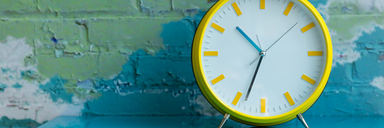 Lesser-Known Effects of Cerebral Palsy Big yellow retro style alarm clock.